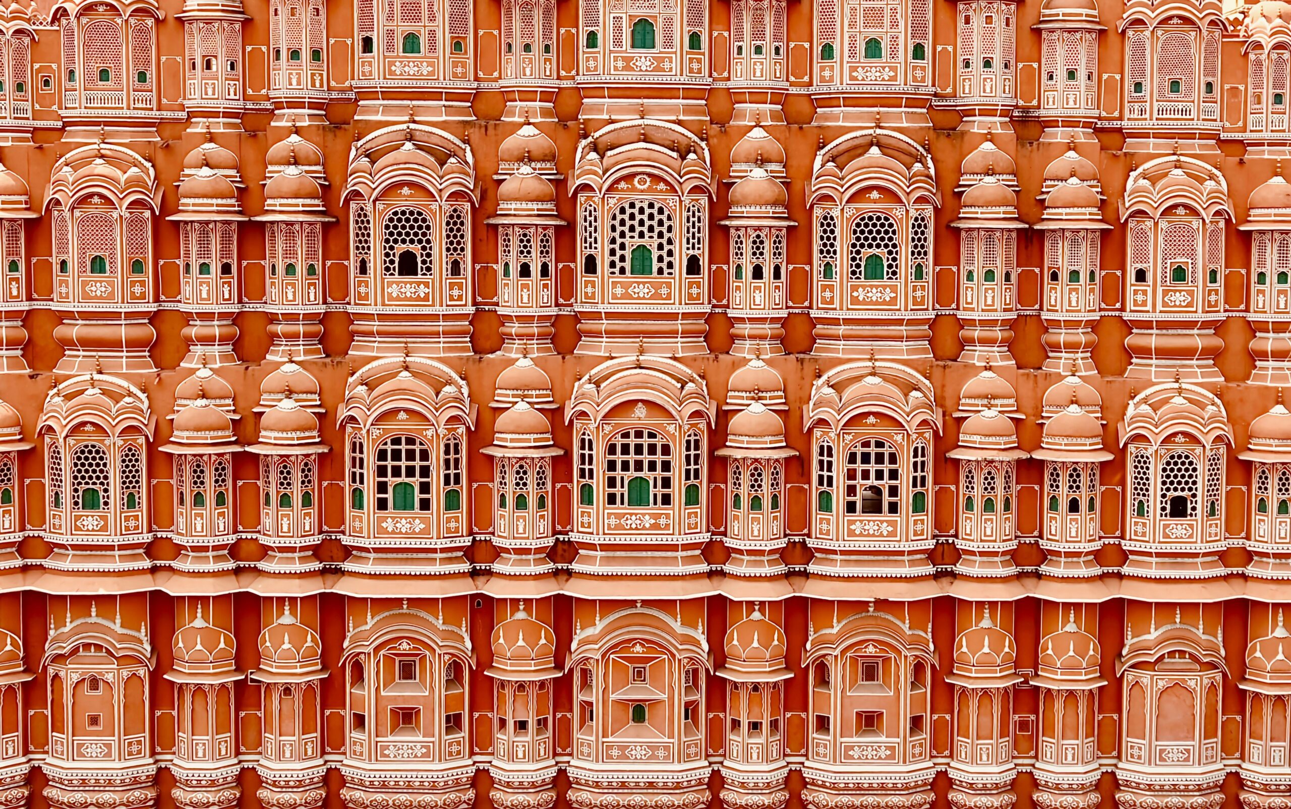 Iconic Hawa Mahal facade in Jaipur, India, showcasing intricate windows and traditional architecture.